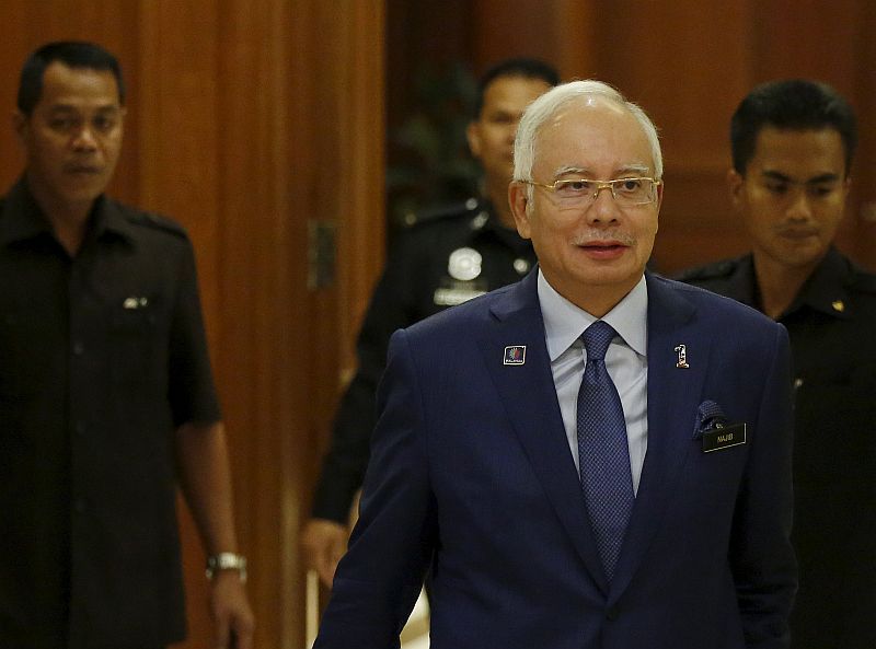 Prime Minister Najib Razak arrives with his security detail at a news conference to announce measures to strengthen the economy in Putrajaya, September 14, 2015. u00e2u20acu201d Reuters pic