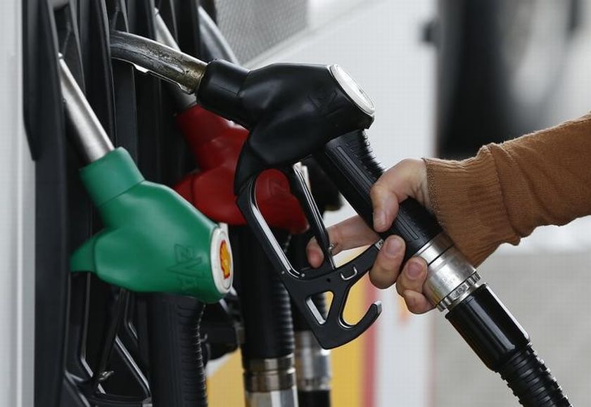 A customer prepares to fill the tank of her car at a fuel station in Sint Pieters Leeuw December 5, 2014. u00e2u20acu201d Reuters pic
