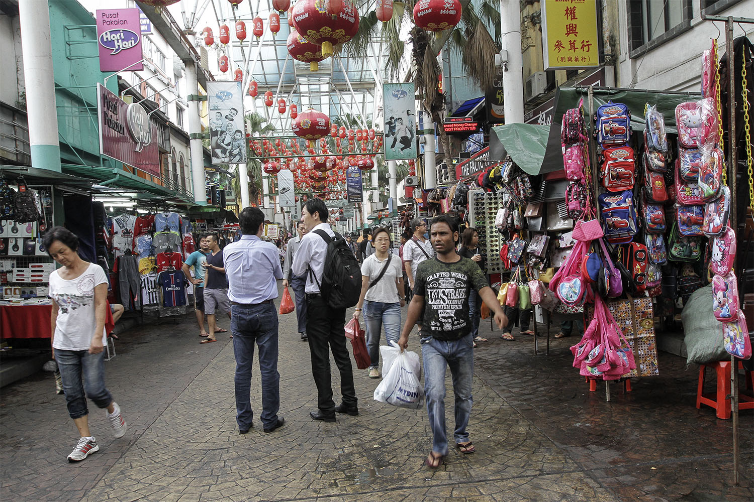 Shoppers walk about in Petaling Street, Kuala Lumpur, September 17, 2015, a day after protesters stormed the popular tourist area during the #Merah169 rally. u00e2u20acu201d Picture by Yusof Mat Isa