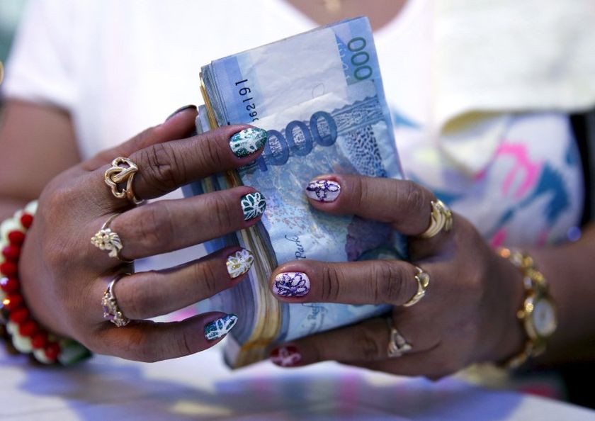A casino financier counts money she collected from a gambler in Angeles city, north of Manila, Philippines, in this picture released October 19, 2015. u00e2u20acu201d Reuters pic