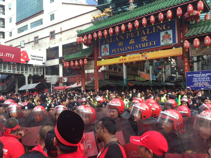 Protesters and riot police still a tight knot at the entrance of Petaling Street, moments after water cannons were fired to disperse the crowd, September 16, 2015.