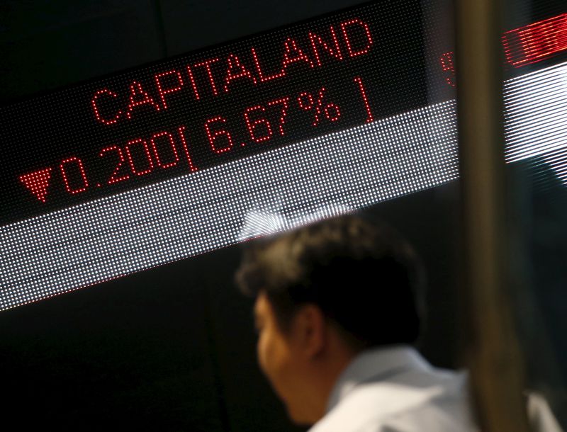 A man passes a stock index board at the Singapore Exchange in the central business district August 24, 2015. u00e2u20acu201d Reuters pic