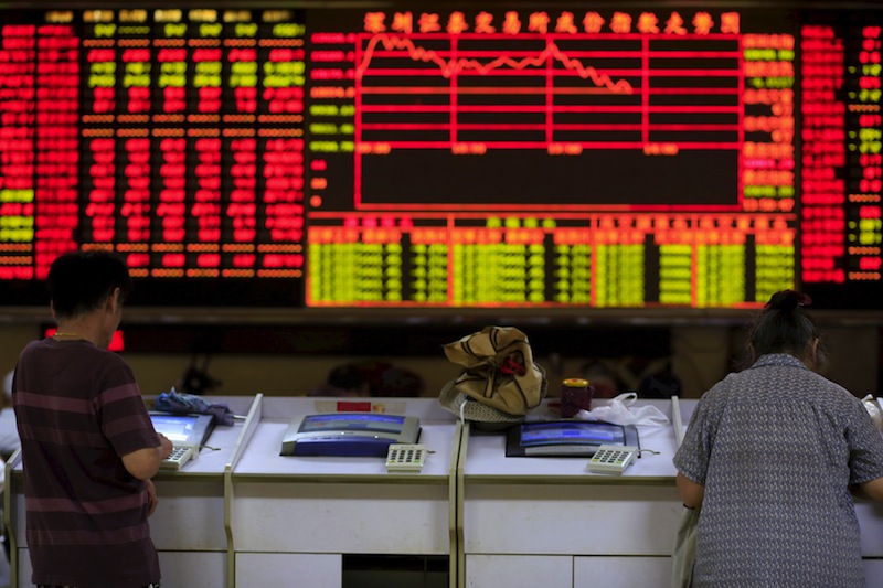 Investors look at computer screens in front of an electronic board showing stock information at a brokerage house in Shanghai, China, in this file picture taken September 7, 2015. u00e2u20acu201d Reuters pic