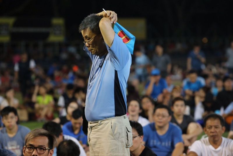 A Workersu00e2u20acu2122 Party supporter listening to the results at Hougang Stadium, Singapore September 11, 2015.  u00e2u20acu201d TODAY pic