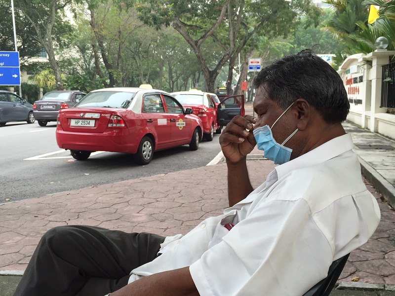 A taxi driver adjusts his face mask while waiting for passengers on a hazy morning in Penang, on October 3, 2015. u00e2u20acu201d Picture by K.E. Ooi