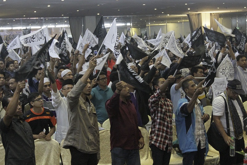 Hizbut Tahrir members waving a flag and shout slogans during  Muktamar Khilafah 2015 at the Hotel Nouvelle in Seri Kembangan, on October 3, 2015. u00e2u20acu201d Picture by Yusof Mat Isa