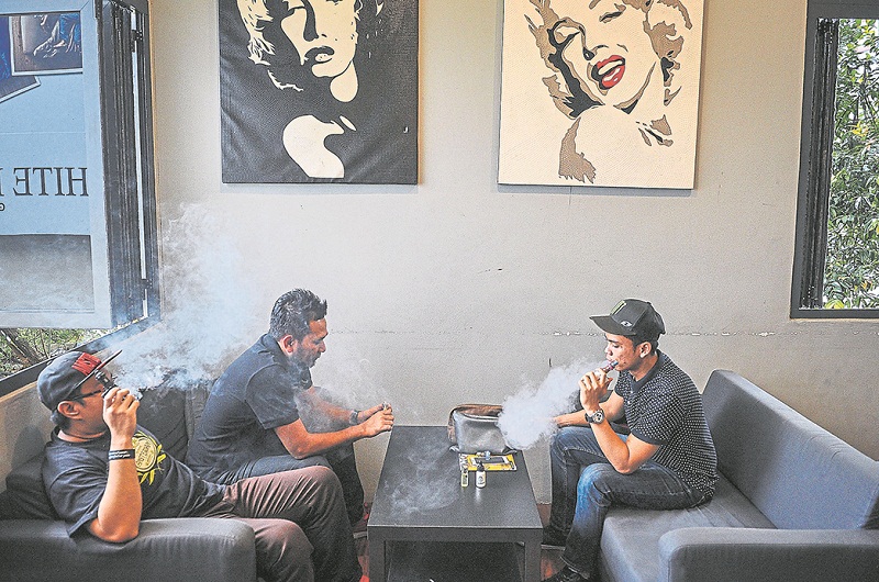 A group of vapers enjoying a puff. The Health Ministry is working on legislation for a total ban on vape devices and accessories due to potential safety hazards. u00e2u20acu201d Picture by Firdaus Latif