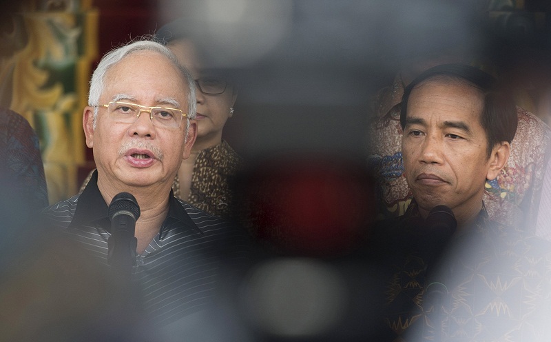 Indonesiau00e2u20acu02dcs President Joko Widodo (right) listens as Malaysiau00e2u20acu02dcs Prime Minister Najib Razak talks to a reporter at the Presidential Palace in Bogor,Indonesiau00e2u20acu02dcs West Java province, October 11, 2015, in this picture taken by Antara Foto. u00e2u20acu201d Reuters pi