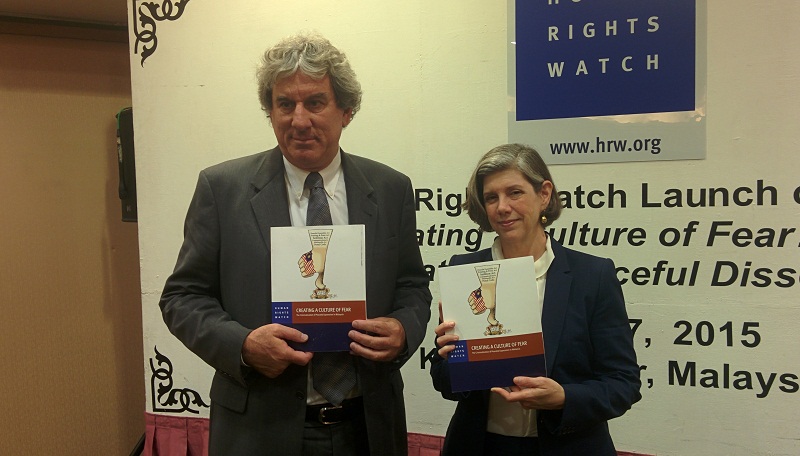 Human Rights Watch (HRW) Asia Director Brad Adams (left) and HRW legal consultant Linda Lakhdhir (right) holding up a copy of HRW's report on Malaysia, after its launch at Park Royal Hotel, Kuala Lumpur, on October 27, 2015. u00e2u20acu201d Picture by Mayuri Mei Lin