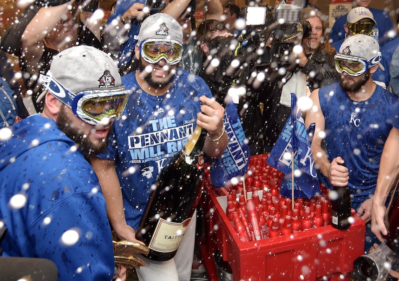 Kansas City Royals third baseman Mike Moustakas (left) and relief pitcher Kelvin Herrera (second from left) celebrate with champagne in the clubhouse after defeating the Toronto Blue Jays in game six of the ALCS at Kauffman Stadium. u00e2u20acu201d Reuters pic