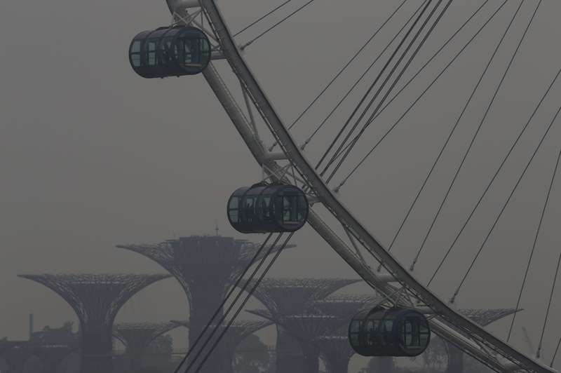 People look out from the Singapore Flyer Observation Wheel in the backdrop of the Gardens by the Bay shrouded by haze in Singapore October 5, 2015.u00c2u00a0u00e2u20acu201d Reuters pic