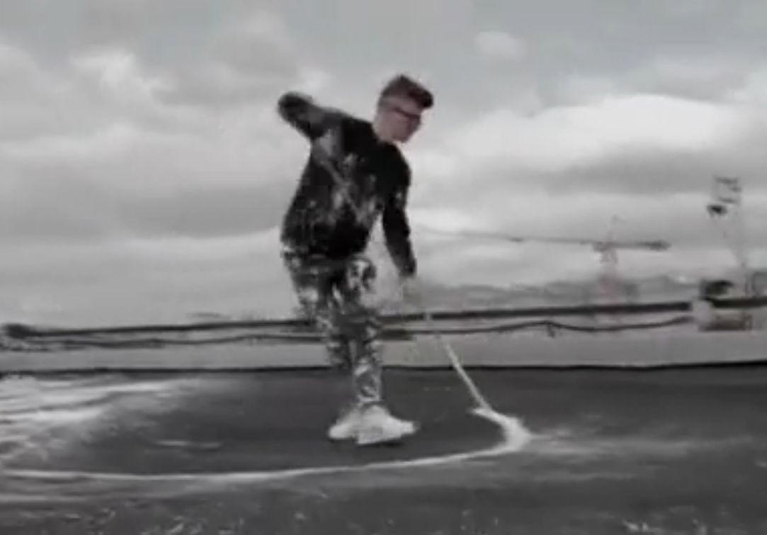 Image from the Reuters video on Russian artist Pokras Lampas working on a rooftop artwork. 