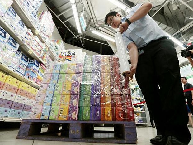 Fairprice staff moves paper products sourced from Asia Pulp & Paper Group, one of the six firms accused of causing forest fires in Indonesia. u00e2u20acu201d Jason Quah/Today pic