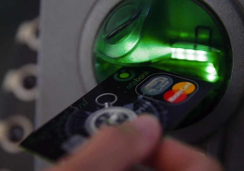 A customer performs a transaction on an ATM at a branch of Hungary's largest lender OTP Bank in central Budapest July 24, 2013. u00e2u20acu201du00c2u00a0Reuters pic