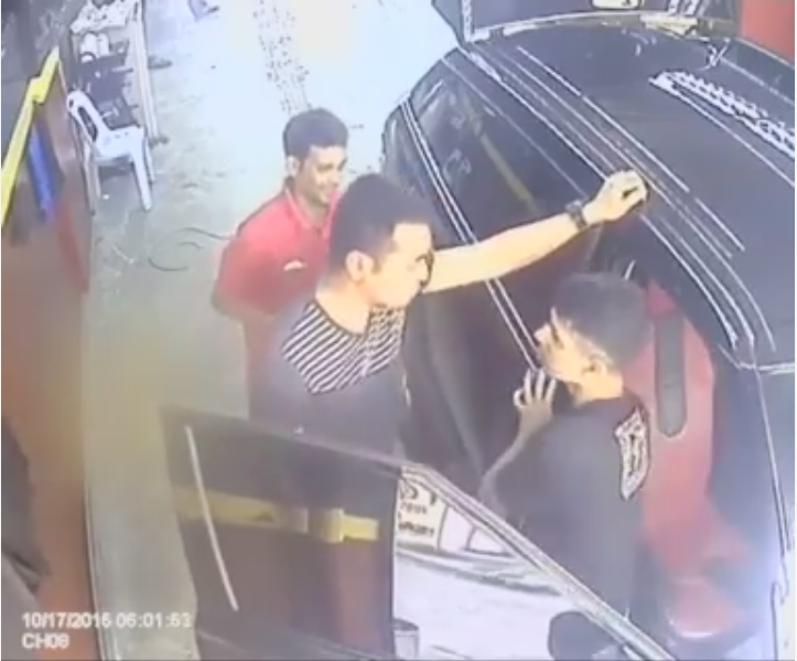 The 30-year-old man (centre) is seen berating the foreign worker in front of his SUV. u00e2u20acu201d Facebook screengrab/ Atie Abdul Hamid