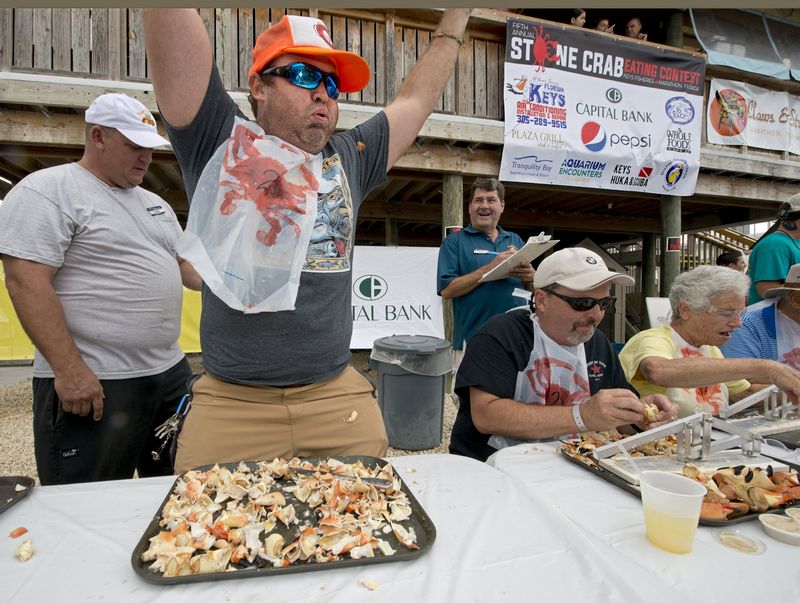Aaron Sutcliffe raises his hands in victory after winning the Stone Crab Eating Contest at Keys Fisheries restaurant in Marathon, Florida October 17, 2015. — Reuters pic