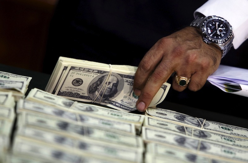 Police officers display counterfeit US dollar bills during a news conference in Lima October 14, 2015.u00c2u00a0u00e2u20acu201d Reuters pic