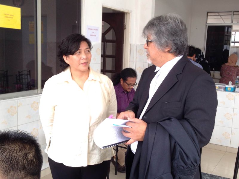 Jannie Lasimbang (left) with counsel Ram Singh before being charged at the Kota Kinabalu magistrate court for offences under the Peaceful Assembly Act. u00e2u20acu2022 Picture by Julia Chan