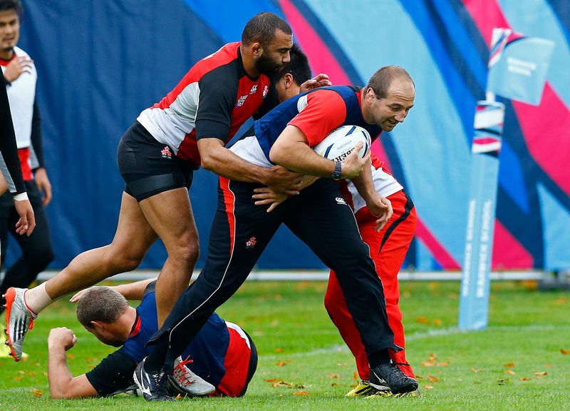 Japan captain Michael Leitch (left) tackles forwards coach Steve Borthwick during training at Warwick School, England October 6, 2015. u00e2u20acu201d Reuters pic 