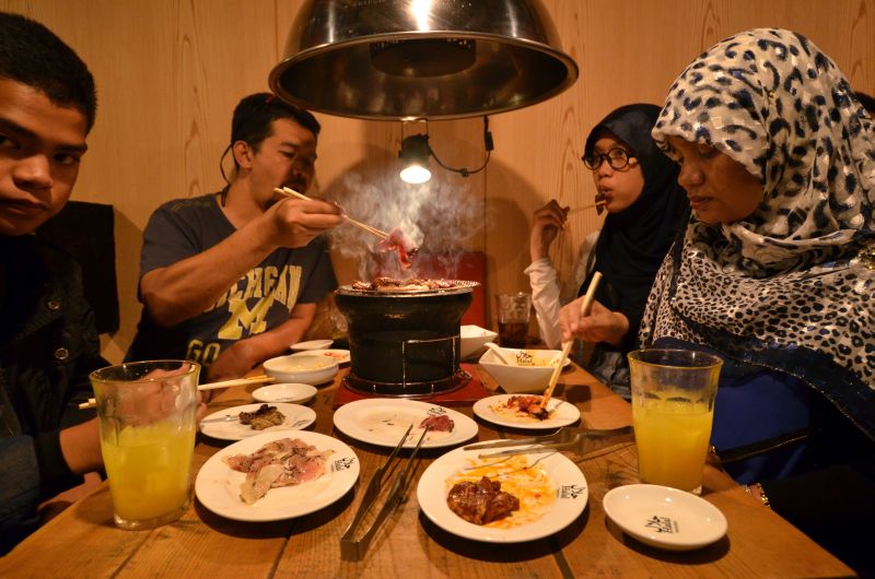 This picture taken on June 24, 2014, shows Thai Muslim tourists enjoying halal-certified foods at a barbecue restaurant in Tokyo.u00c2u00a9AFP PHOTO / Yoshikazu TSUNO