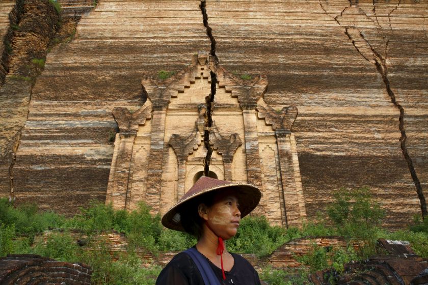 Handicraft vendor Zar Zar, 28, poses as she waits for tourists in front of the ruins of the temple Pahtodawgyi in Mingu, Myanmar.