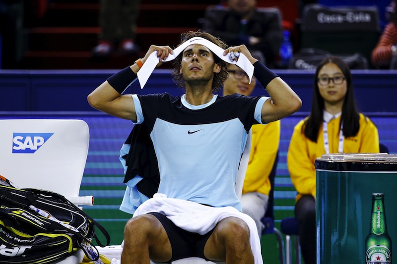 Rafael Nadal of Spain changes headband in between games against Jo-Wilfried Tsonga of France in their men's singles semi-final match at the Shanghai Masters tennis tournament in Shanghai, China, October 17, 2015.  u00e2u20acu201d Reuters pic