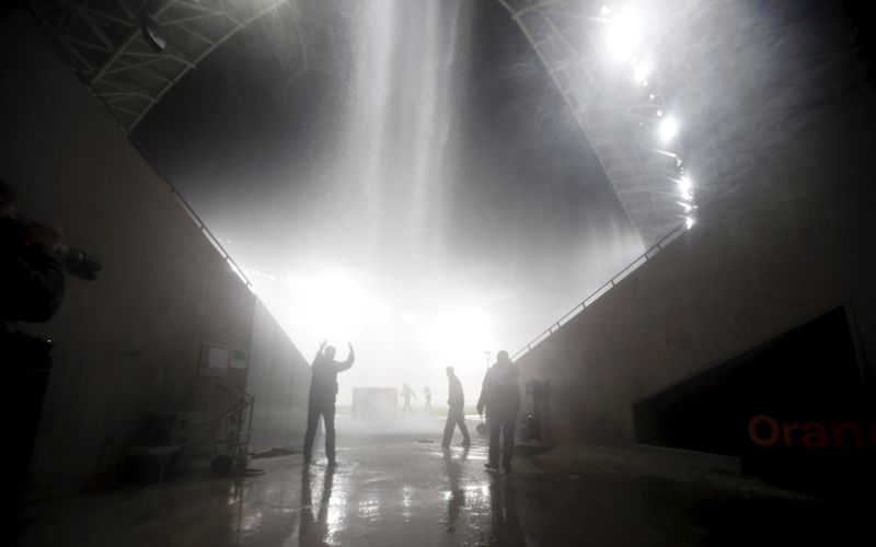 A man runs to protect himself from heavy rain at Allianz Riviera stadium in Nice, October 3, 2015. u00e2u20acu201d Reuters pic