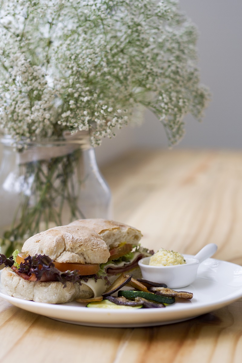 Wild Sheep Chase’s ciabatta sandwich with ham and cheese, served with a side of egg mayo and grilled vegetables.