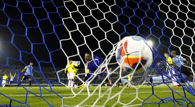 Colombia's goalkeeper David Ospina (centre) fails to save a goal by Uruguay's Diego Godin during their 2018 World Cup qualifying  match at the Centenario stadium in Montevideo, Uruguay, October 13, 2015. u00e2u20acu201d Reuters pic