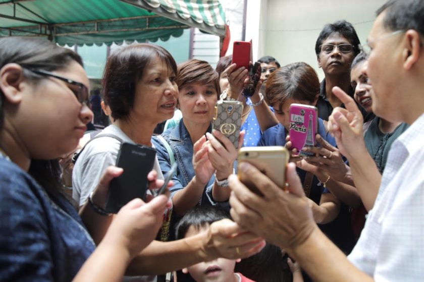 St Thomas Moreu00e2u20acu2122s parish priest Rev Father Raymond Pereira showing off the pictures of the Virgin Mary statue that was said to have shed tears. u00e2u20acu201d Picture by Choo Choy May