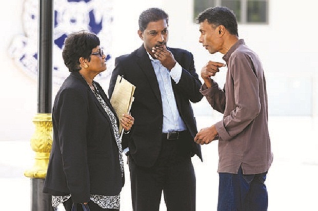 Richard (right) talks to his lawyers outside the Sentul police station yesterday. u00e2u20acu201d Picture by Ahmad Zamzahurin