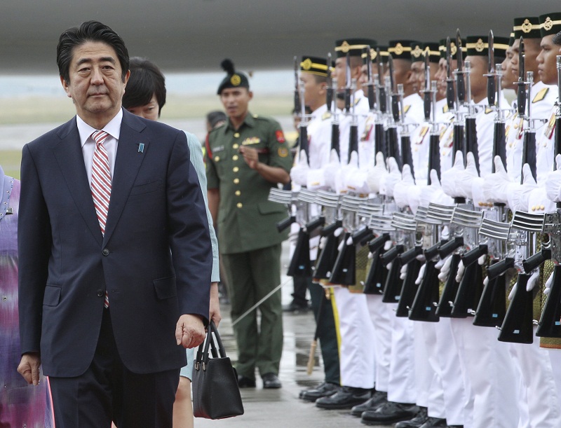 Japan’s Prime Minister Shinzo Abe walks past a guard of honour as he arrives for the 27th Association of Southeast Asian Nations (Asean) Summit in Kuala Lumpur, November 20, 2015. — Reuters pic