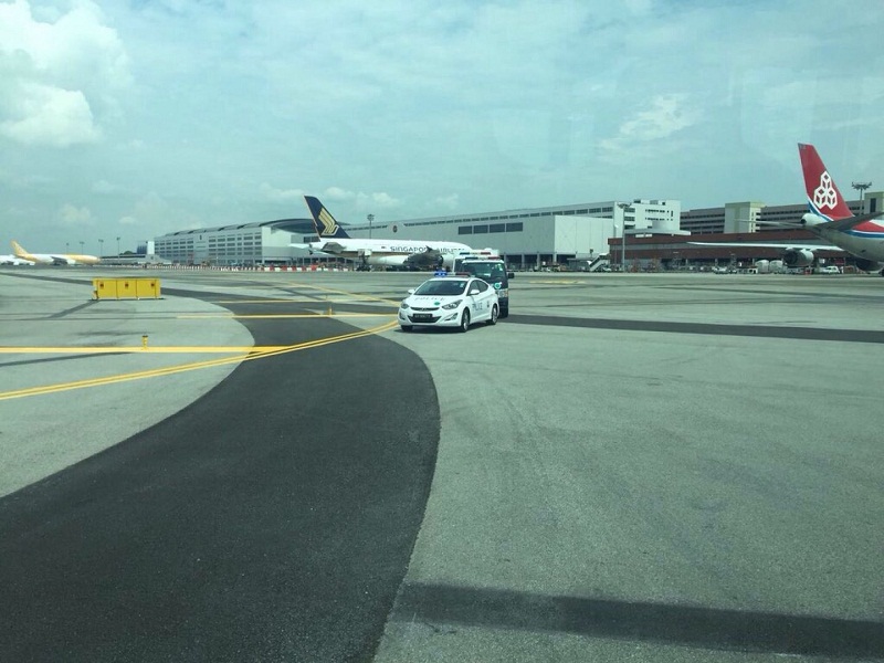 In this photo supplied by an affected passenger onboard SQ1, airport security vehicles were seen in action at Changi Airport. u00e2u20acu201d TODAY pic
