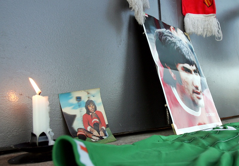 File picture of a candle standing next to portraits of former Manchester United footballer George Best outside Old Trafford stadium in Manchester, 25 November 2005. u00e2u20acu201d AFP pic
