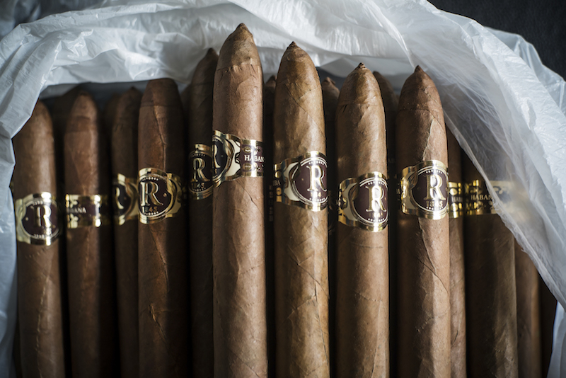 Hand-rolled cigars with the distinctive Vegas Robaina band, west of Havana in San Luis, Cuba, May 29, 2015. The Vegas Robaina tobacco plantation, founded in 1845, is known for producing high quality wrapper leaves. — Picture by Todd Heisler/The New York Times