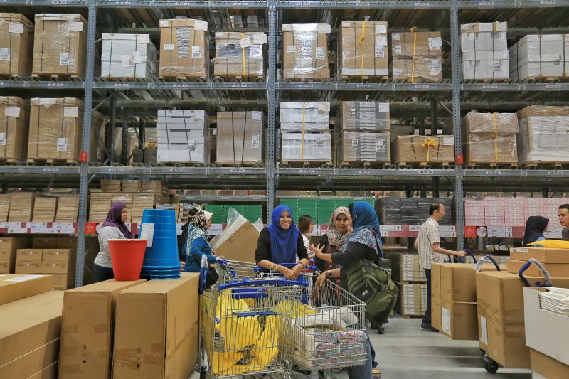 Customers take a breather while shopping in the 42,000 square metre spanking new Ikea branch in Cheras. ― Picture by Saw Siow Feng
