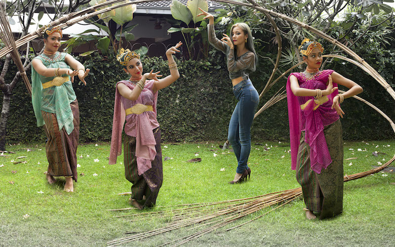 The photographs feature traditional Malaysian dancers alongside a trendy K-Pop dancer.