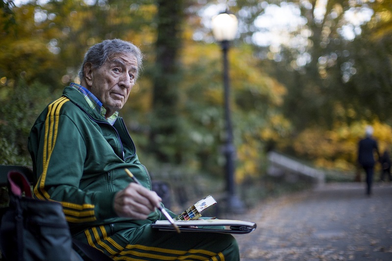 Tony Bennett works on a watercolour on a park bench near the south entrance to Central Park in New York, November 3, 2015.u00e2u20acu201d Picture by Damon Winter/The New York Times 