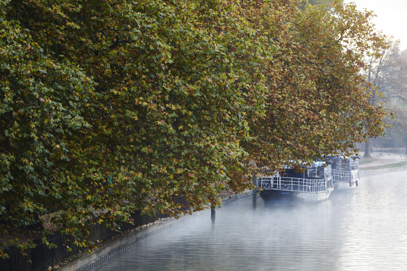 Boats in early-morning mist on the River Thames near Folly Bridge, Oxford, England, October 2015.