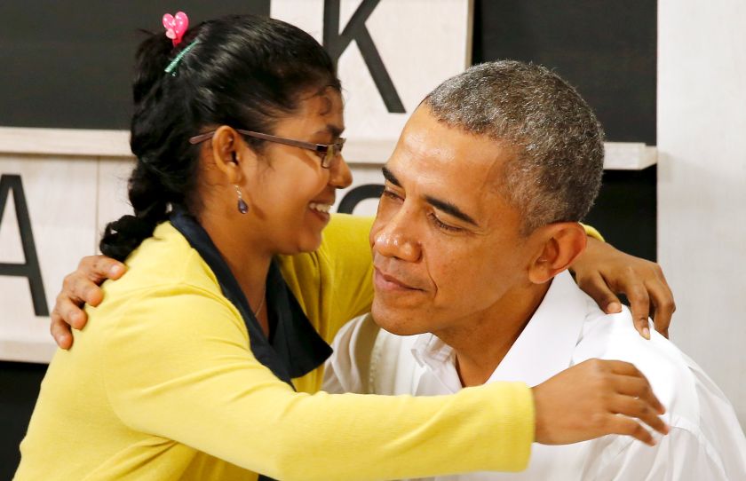 US President Barack Obama smiles with a 16-year old refugee, a victim of human trafficking who will soon be resettled in the US, as he tours the Dignity for Children Foundation, an education program for refugee children, in Kuala Lumpur, Nov 21, 2015.