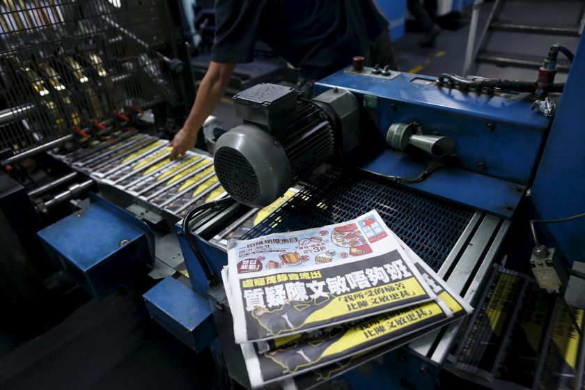 nAn employee takes a copy of the Apple Daily newspaper, published by Next Media Ltd, at the company's printing facility in Hong Kong, China November 30, 2015. u00e2u20acu201d Reuters picn
