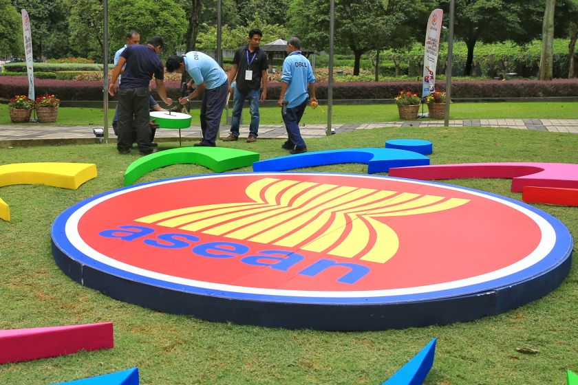 Workers are pictured getting the Asean logo ready at the Kuala Lumpur Convention Centre, November 17, 2015. u00e2u20acu201d Picture by Saw Siow Feng
