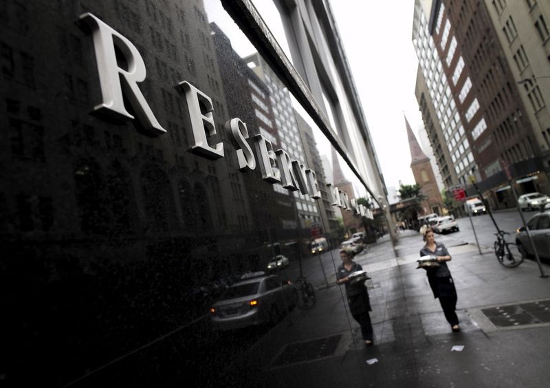 A woman delivering catering for a Melbourne Cup lunch walks past Australia's Reserve Bank in Sydney, November 3, 2015. u00e2u20acu201d Reuters pic