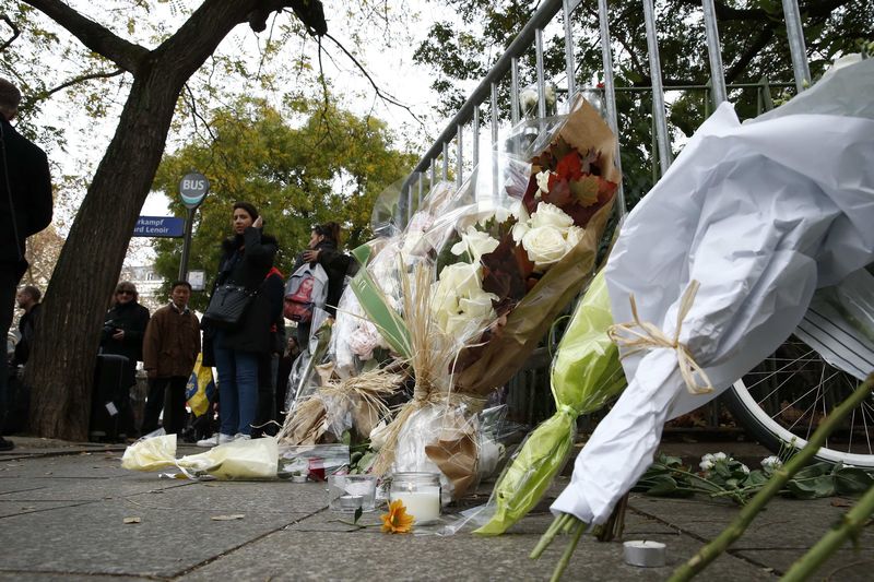 Memorial bouquets of flowers are placed on barriers near the Bataclan concert hall the day after a series of deadly attacks in Paris, France, November 14, 2015. u00e2u20acu201d Reuters