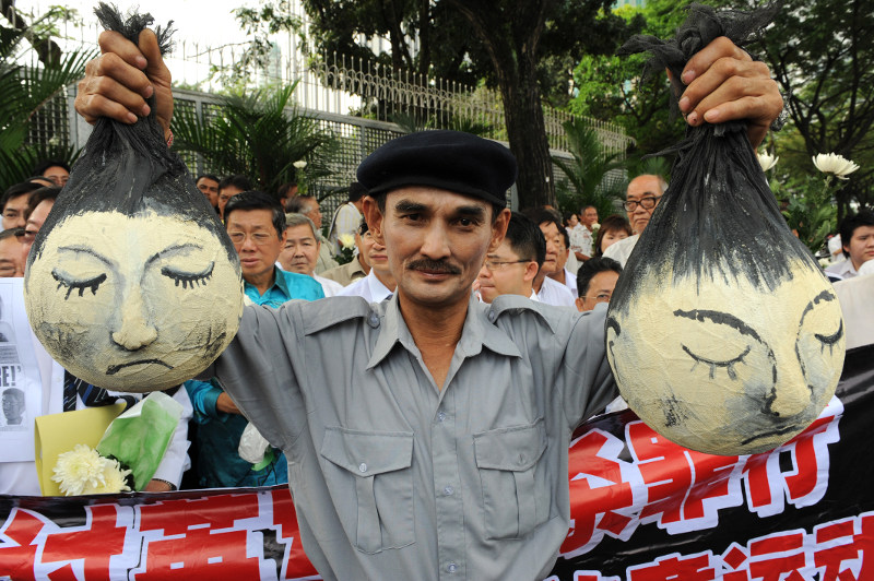 File picture shows a protestor, acting as a British soldier, portraying a massacre scene during a protest in front of the British high commission building in Kuala Lumpur on December 12, 2008. u00e2u20acu201d AFP pic