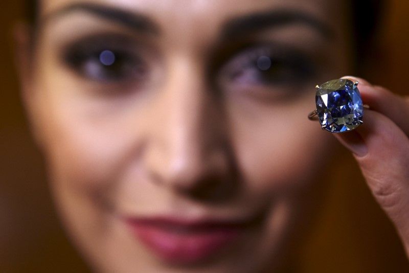 A model poses with a 12.03 carats cushion-shaped fancy vivid blue diamond mounted on a ring at Sotheby's auction house in Geneva, in this November 4, 2015 file photo. u00e2u20acu201d Reuters pic