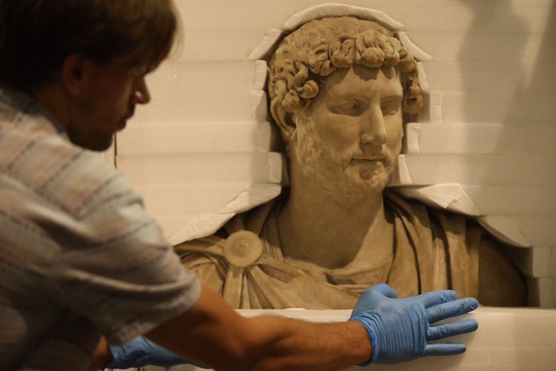 A marble sculpted bust of Emperor Hadrian from AD 125-130 is carefully padded with foam as it is put away in preparation for its debut after being photographed during a media preview at the National Museum. — TODAY pic