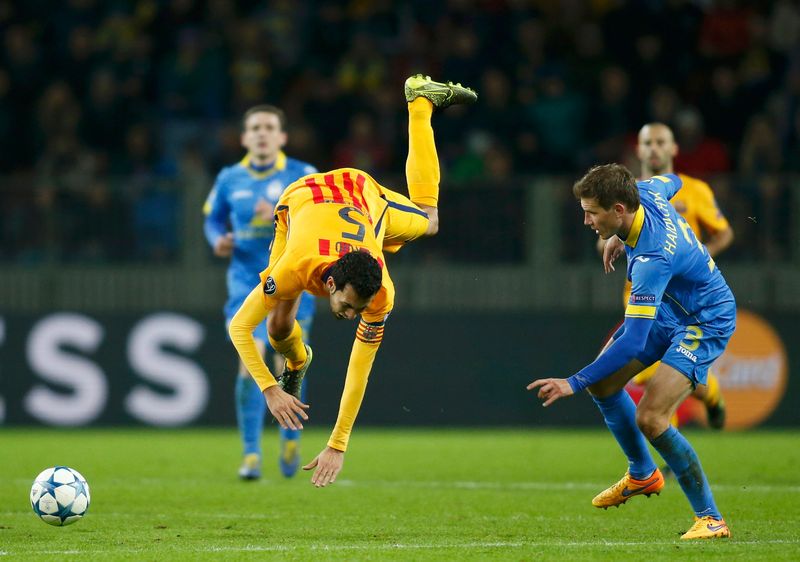 Barcelona's Sergio Busquets goes tumbling next to BATE Borisov's Vitali Gaiduchik during their Champions League group E match at the Borisov Arena stadium outside Minsk, Belarus, October 20, 2015. u00e2u20acu201d Reuters pic 