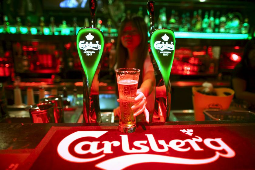 A bartender serves a glass of Carlsberg beer at a bar in Kuala Lumpur in this picture released November 9, 2015. u00e2u20acu201d Reuters pic