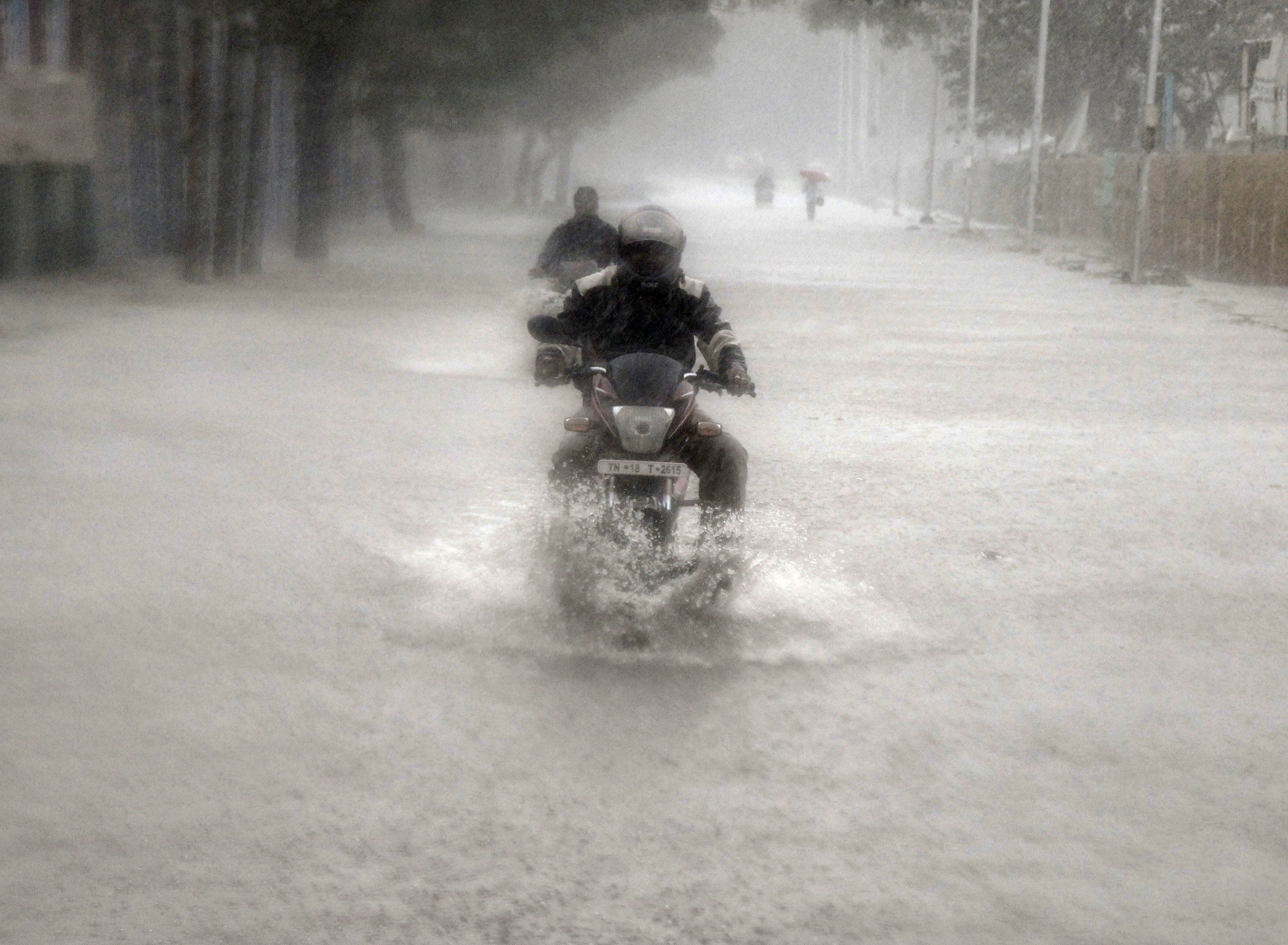 A man rides his motorbike through a flooded road during heavy rain in Chennai, India, November 9, 2015 u00e2u20acu201d Reuters pic
